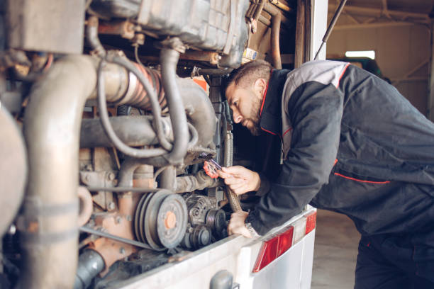 istock Male mechanic working on a bus motor 1310002566