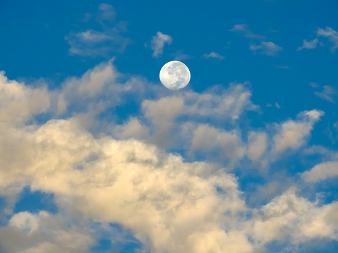 Bright moon in a dark cloudy sky