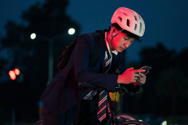 istock Asian men on bicycles back from work in the evening.He stopped at the traffic lights and use the phone 1310011591