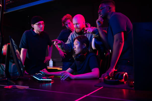 istock During a training session before the Dota 2 championship, the coach explains their strategy to the team, the girl plays at the computer 1310013196