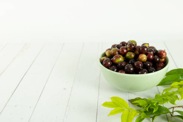 istock Jabuticaba fruit in a bowl and a white background with jabuticaba leaves. Brazilian typical fruit 1310016387