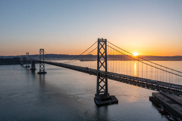 bay bridge in san francisco - bay bridge bridge california dawn stock-fotos und bilder