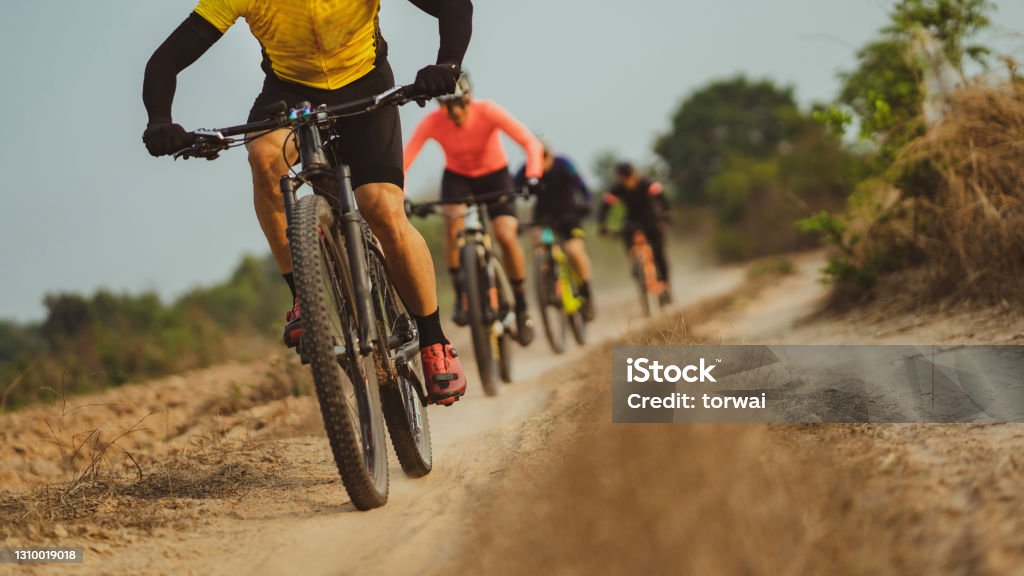 Group of Asian cyclists, they cycle through rural and forest roads. Cycling Stock Photo