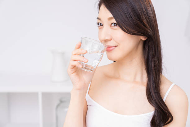 istock attractive asian woman who drinks water 1310020701