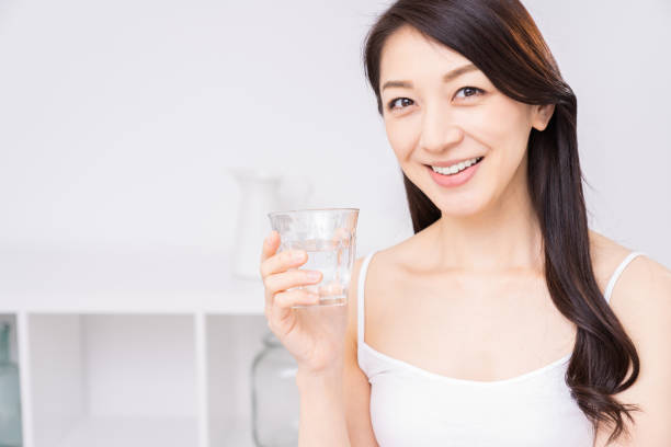 istock attractive asian woman who drinks water 1310020713