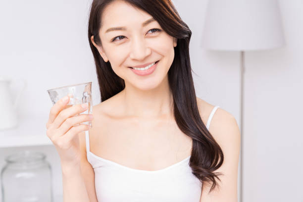 istock attractive asian woman who drinks water 1310020751