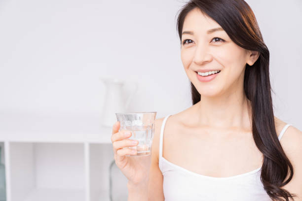 istock attractive asian woman who drinks water 1310020755