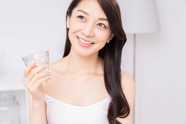 istock attractive asian woman who drinks water 1310020757