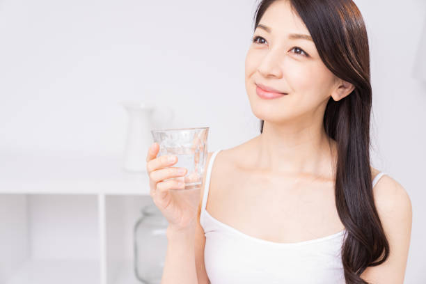 istock attractive asian woman who drinks water 1310020778