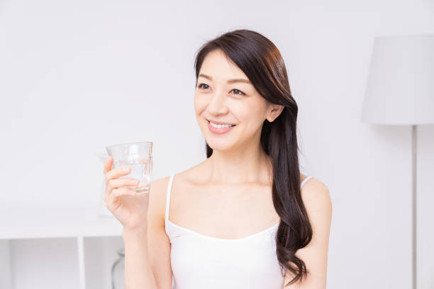 istock attractive asian woman who drinks water 1310020799