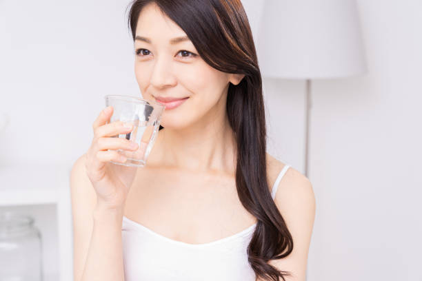 istock attractive asian woman who drinks water 1310020812