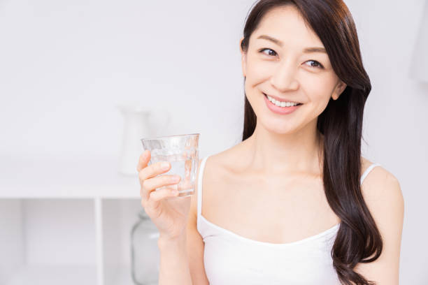 istock attractive asian woman who drinks water 1310020830