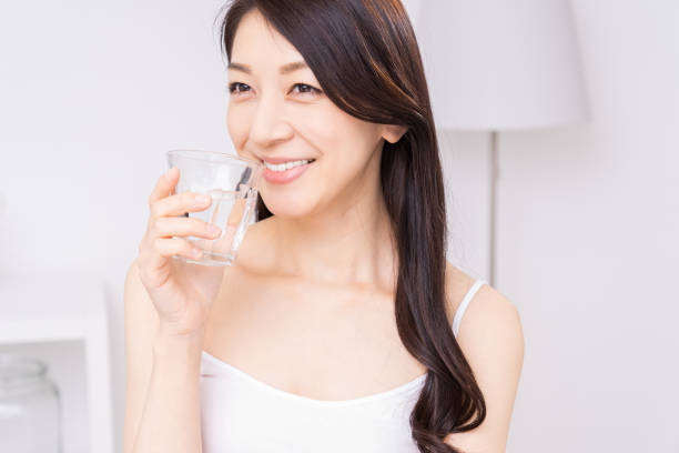 istock attractive asian woman who drinks water 1310020835