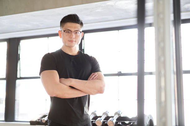 istock Asian male trainer with arms folded looking at the camera 1310021478