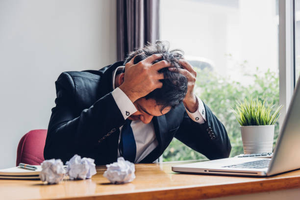 istock Asian young business man tired strain failure on he work 1310022239