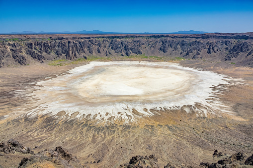 Al Wahbah Crater, a volcanic crater in Saudi Arabia, on a sunny day.