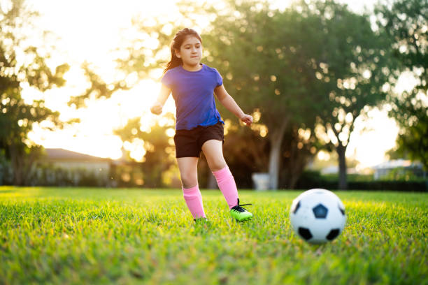istock Girl kicking a soccer ball 1310024701