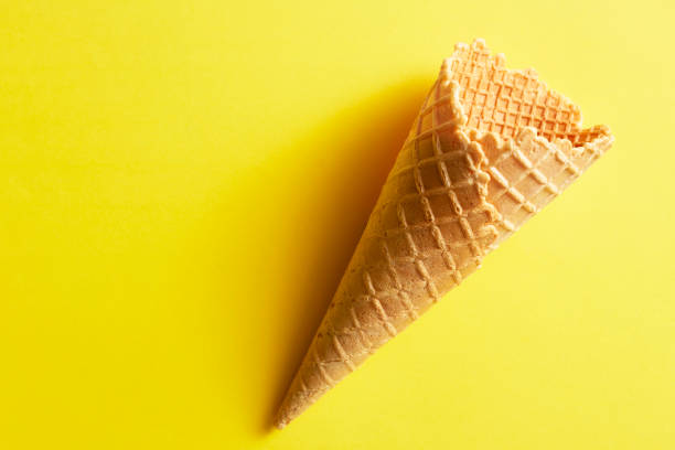 istock Ice cream cones on yellow background 1310025697