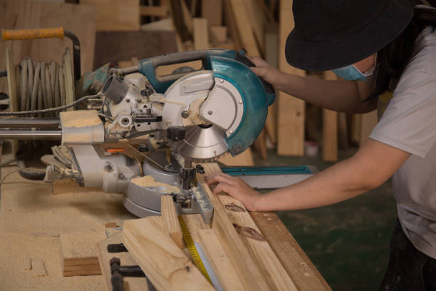 istock Carpenter working on wood with electric circular saw in workshop. Joinery work on the production of wooden furniture. Small Business Concept 1310032593