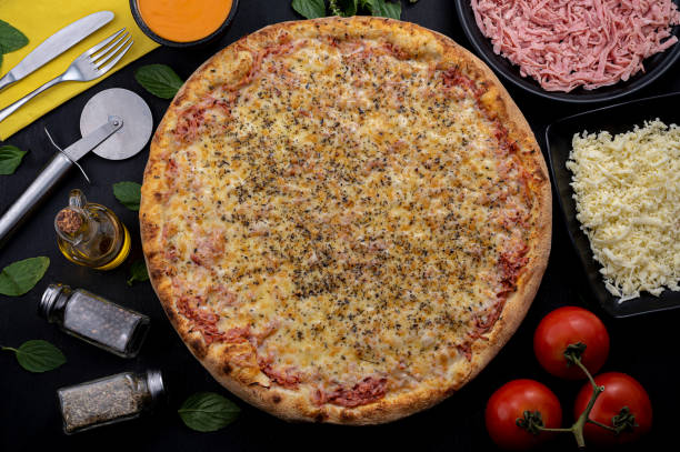 istock Pizza with mozzarella cheese, ham and tomato sauce 1310034031