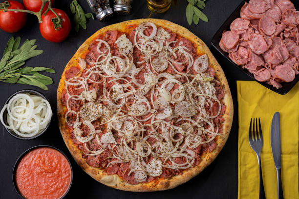 Pepperoni sausage pizza, mozzarella cheese, tomato sauce and onion Pizza with ingredients around pepperoni pizza stock pictures, royalty-free photos & images