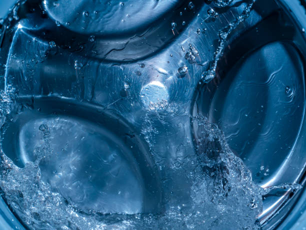istock Rotating drum in the washing machine tub with water. 1310036586
