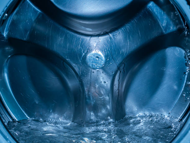 istock Rotating drum in the washing machine tub with water. 1310036587