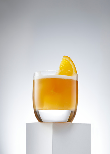 The whiskey sour is a mixed whiskey cocktail drink garnishing with a fresh orange.