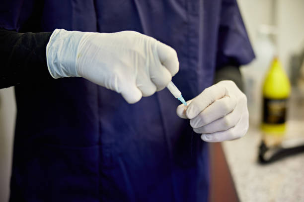 istock Doctor in Surgical Gloves Preparing Syringe 1310040383