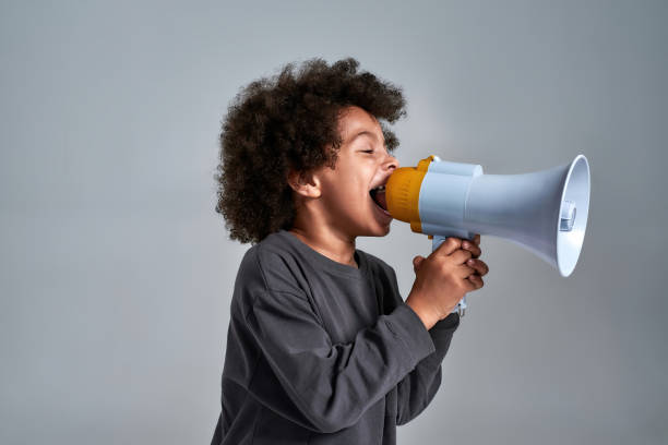 istock African american boy screaming into loudspeaker 1310040469