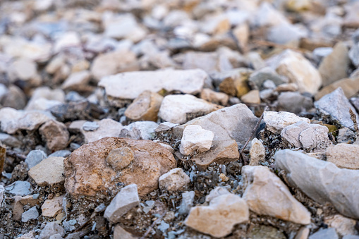 Gray gravel, crushed stone close-up, front view. Photos with low depth of field. High quality photo