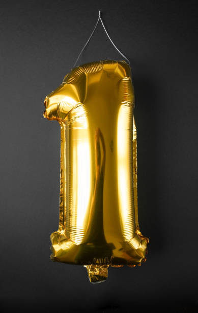istock Gold foil Balloon number one isolated on black 1310042011
