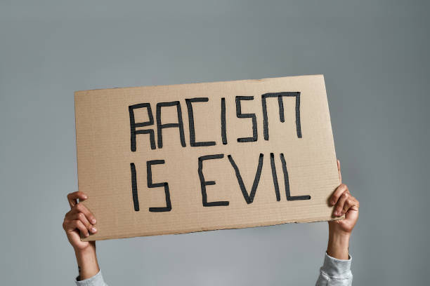 istock Placard with Racism is Evil inscription held by man 1310042205