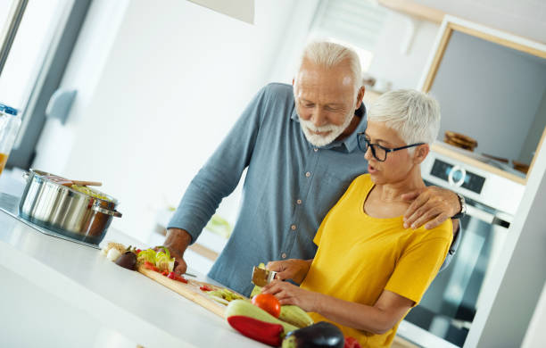 istock Mature couple cooking lunch together. 1310042253