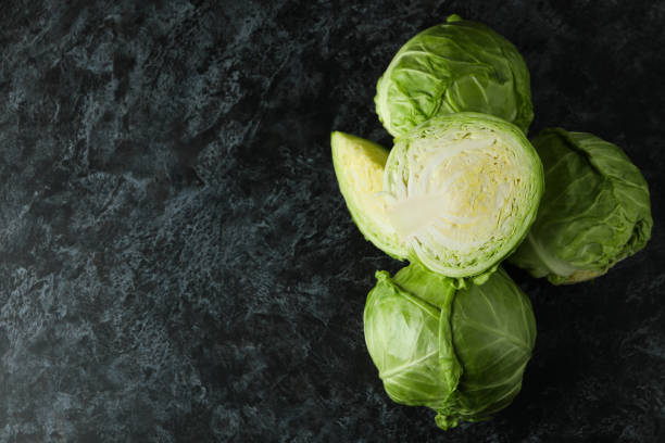 istock Fresh green cabbage on black smoky table 1310043416