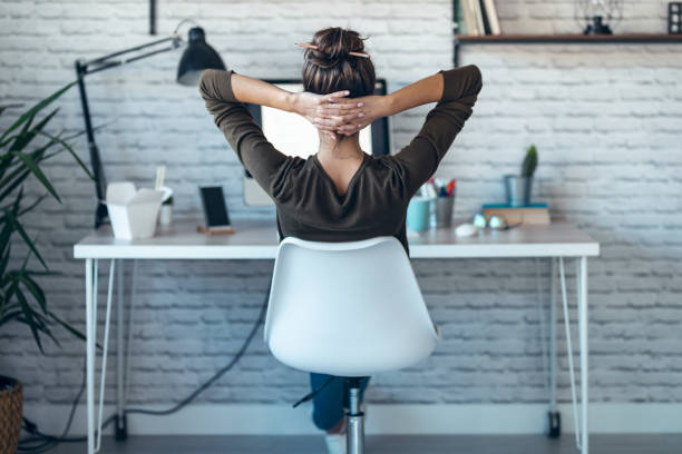 istock Beautiful businesswoman stretching body for relaxing while working with computer in the office at home. 1310044324