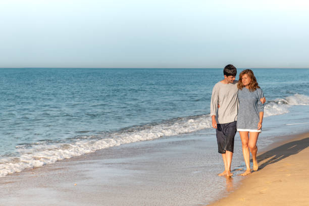 istock Mother and son talking and strolling on the beach 1310044347