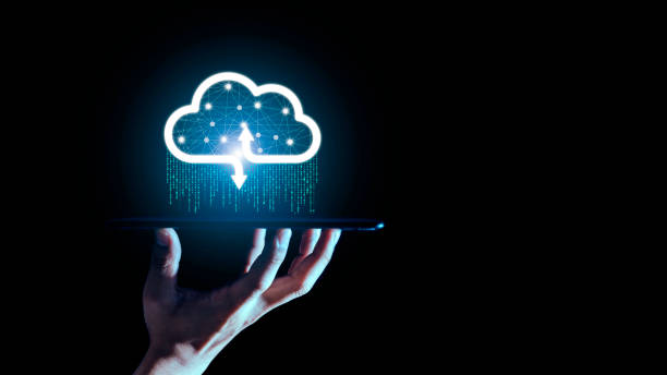 istock Businessman holding a cloud data icon with light and the binary number 1010. The concept of digital traffic is connected to the cloud. 1310044503