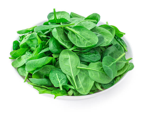 istock Fresh spinach leaves in bowl isolated on white background. Macro. Top view. Flat lay.
