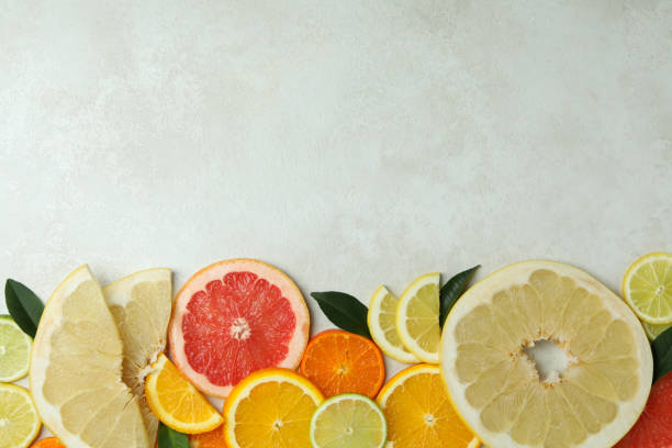 istock Ripe citrus slices on white textured background 1310045267