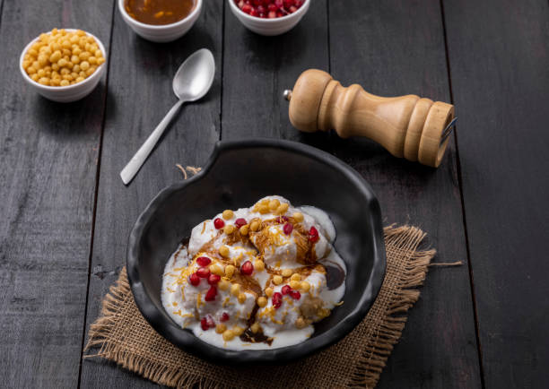 istock Super soft  Dahi Bhalla or Dahi Vada served in a black bowl 1310045472
