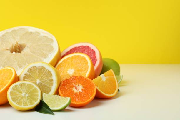 istock Citrus on white table against yellow background, space for text 1310045476