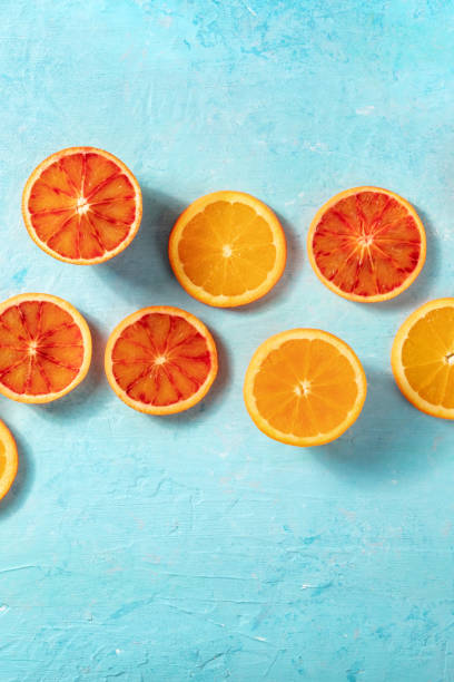 istock Oranges of various types, shot from the top on a blue background 1310045691