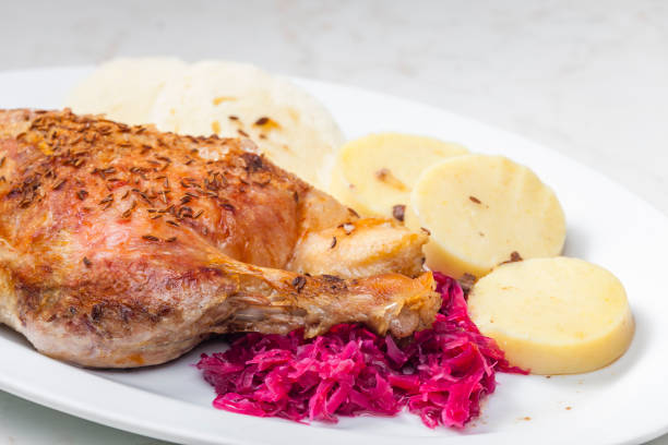 istock roasted goose leg with red cabbage and dumplings 1310046864
