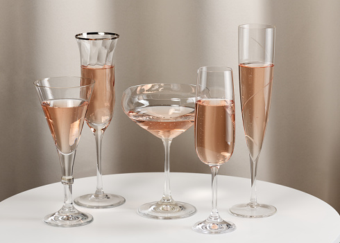 Arrangement of different glasses with rose wine