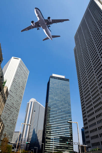 istock Low angle view of flying airplane over the skyscrapers 1310049044