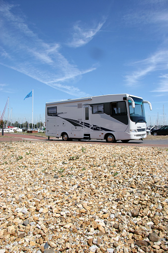 Bosham Sussex England. An American recreational vehicle or motorhome parked on a beach with water views. No people