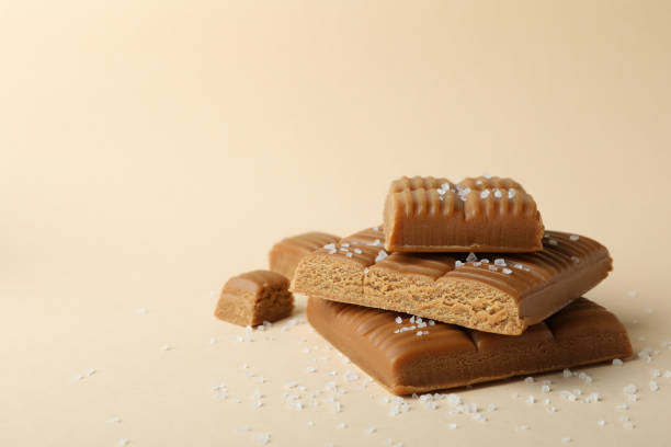 istock Salted caramel pieces on beige background, space for text 1310050846