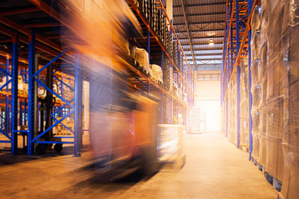 istock Speed Motion Blur of Forklift Driver Working at the Warehouse. 1310052531