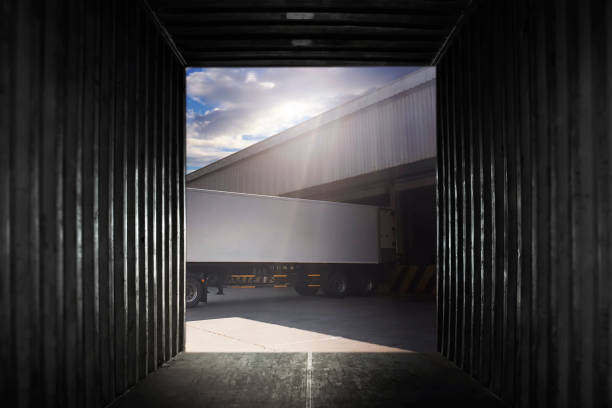 istock Inside View of Cargo Container Truck Parked Loading at Dock Warehouse. Cargo Freight Truck. Shipping Warehousing Logistics and Transpoartation. 1310052541